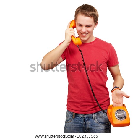 portrait of a young man talking on a vintage telephone over a white background