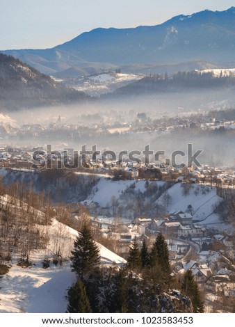 Winter rural scene in the mountains. Carpathians mountains, Romania. Countryside landscape in Transylvania