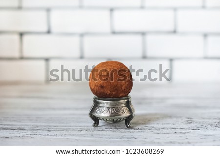 A beautiful picture of a cake. A round of potato cake one on a white brick wall background. Place and background for your text.