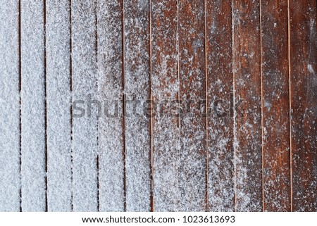 snow-covered wooden background
