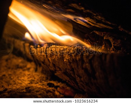 Burning woodfire in a fireplace on a black background