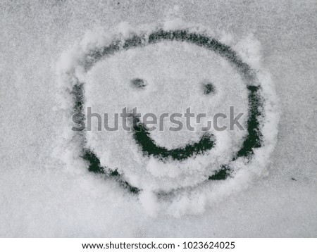 smiley drawn on snow