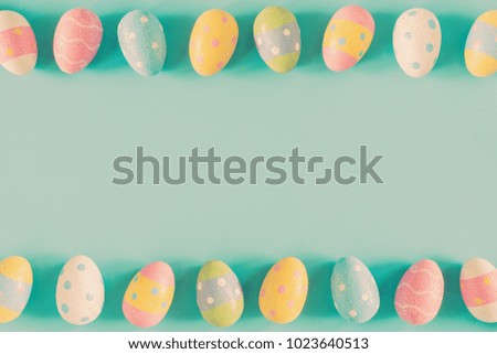 Colorful easter eggs on pastel color background with space.