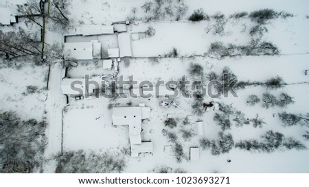European village from a height. Winter cold picture of the roofs of houses.