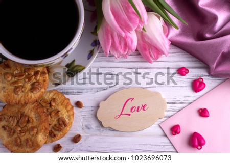 Valentines day greeting card with pink tulips coffe cup cookies and lettering Love