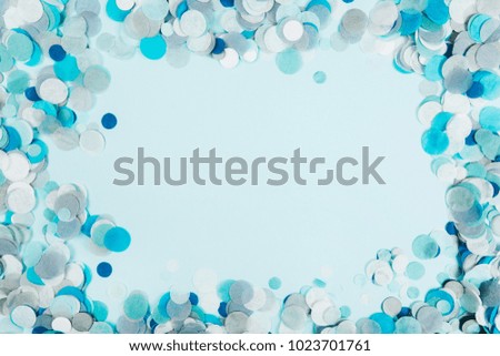 Blue confetti on blue pastel background. Festive backdrop for your design.