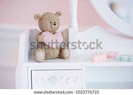 Elements of the interior of the children's room in pastel colors. Flowers, toys, candles, calendars, mirrors