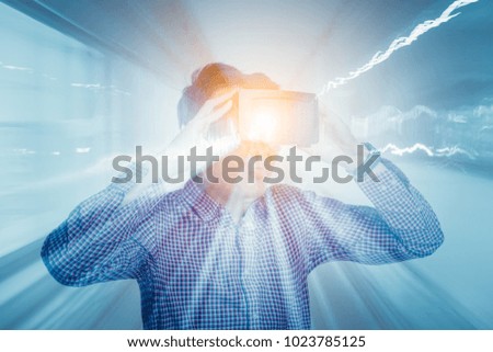 Double exposure of young asian handsome man wearing virtual reality or VR glasses with motion blurred.