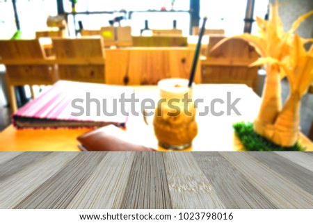 Wood table top on blur background,coffee shop