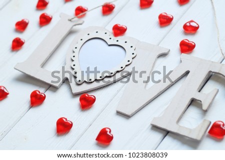 heart and word ''love'' on wooden wall
