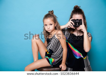 two girls with a camera on a photo shoot