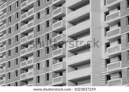 Construction of a multi-storey brick apartment house, black and white frame