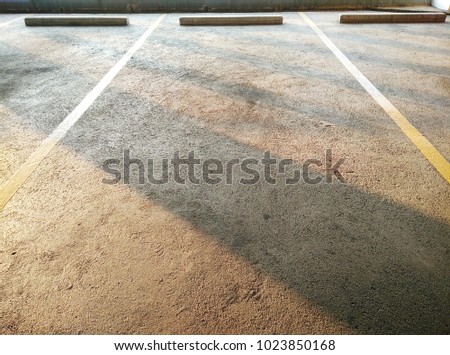 Parking in the building.The barrier of the car park is made of cement.Indoor parking