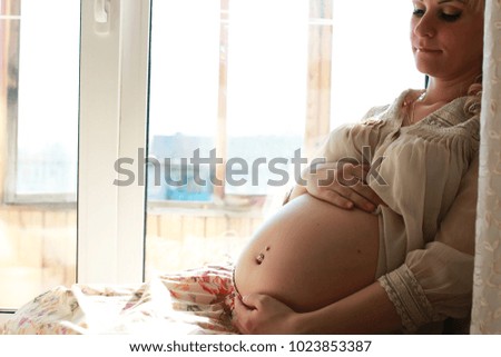 Beautiful girl pregnant blonde prepares to become a mom