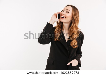 Gorgeous pleased woman having brown beautiful hair talking on mobile phone and having pleasant talk isolated over white background