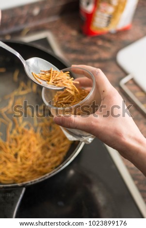 cooking a spanish fideua, a typical noodles casserole with seafo