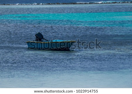 Boat anchored over calm blue sea on Maafushi island, Maldives