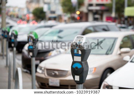 Parking machine with electronic payment in the city streets and a row of cars Royalty-Free Stock Photo #1023919387