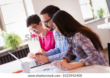 Picture of young architects discussing in office