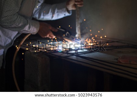 Blurred of worker are using steel welding equipment.