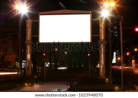 Blank advertisement board on street at night