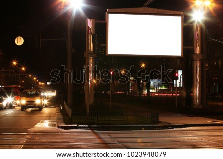 Blank advertisement board on street at night