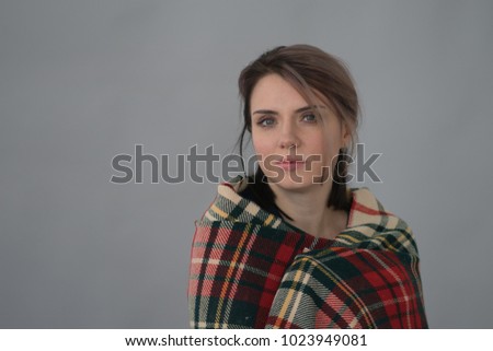 
portrait of a beautiful girl in a checkered scarf in the studio