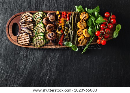 food background of vegetables on the grill . healthy summer food on black shale