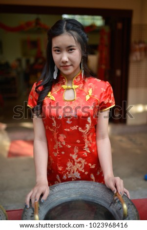 Portrait of beautiful asian woman in red chinese dress traditional cheongsam.
