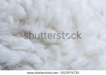 Close-up white pattern of structure of cloth knitting from yarn and natural rabbit fur. Selective focus.