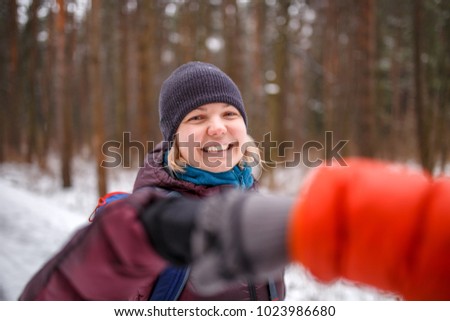 Photo of people making handshake in winter forest