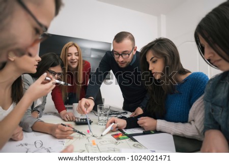 Colleagues having a meeting with client in conference room. Group of people having a conversation while showing designs to client for approval. Business concept.
