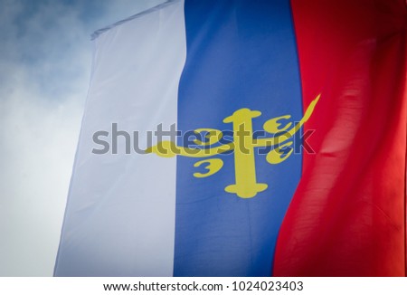 flag of the Serbian orthodox church close up with cloudy blue sky  Royalty-Free Stock Photo #1024023403