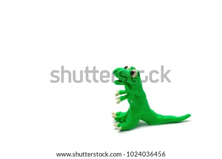Colorful Play dough T- rex or Tyrannosaurus or dinosaur create mold by baby boy isolated on white background with copy space for text. Kids toys children's development concept.