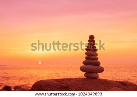 Stones balance on a background of sea sunset. Calm and meditation. Concept of harmony and balance Royalty-Free Stock Photo #1024049893