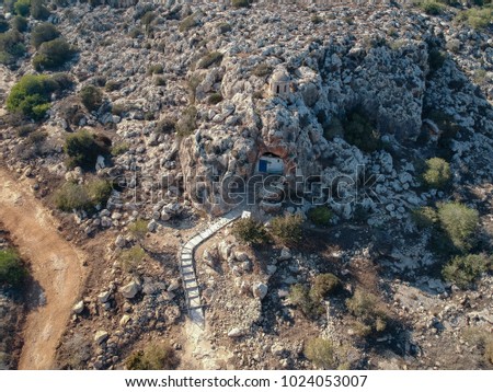 Birds eye view of cave church hidden in mountain rock formation in the Mediterranean