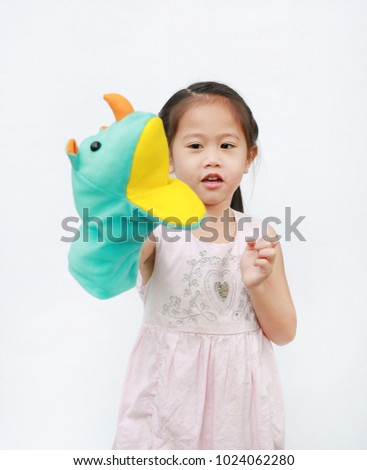 Little Asian child girl hand wear and playing Rhinoceros puppets on white background. Educations concept.