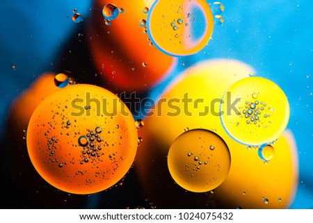 Yellow-blue abstract background from oil on the surface of the water