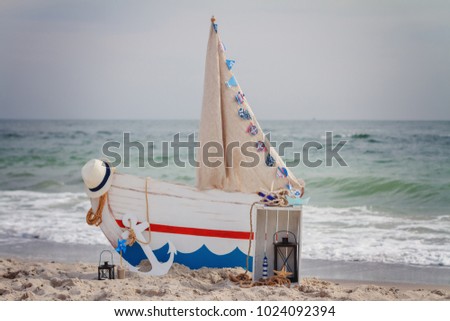 Sea decor on the beach / Boat, anchor, hat, drawer, rope / copy space