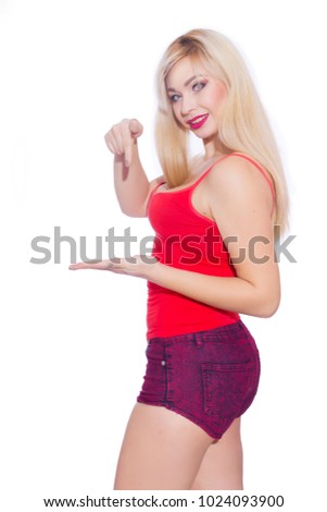 Photo of a beautiful blonde woman on white isolated background showing something on her hand