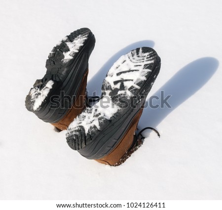 Boots in the snow-person stuck in snow upside down humorous picture Outdoor photography Concept photography 2018 Royalty-Free Stock Photo #1024126411