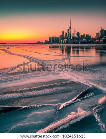 Toronto, Ontario. Canada. Sunset view over frozen lake Ontario from Polson Pier looking at the downtown Toronto city skyline.