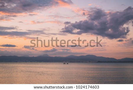 Two sailboats in a calm peaceful sea in the evening, Spain