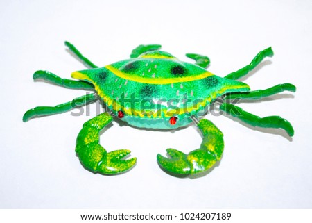 green crab toy on white background