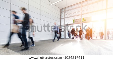 blurred anonymous people walking in a corridor