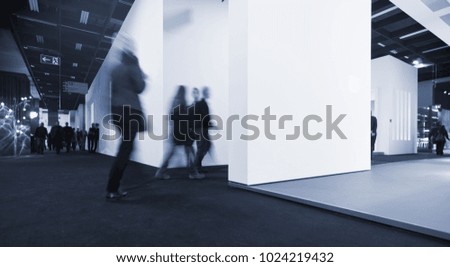blurred anonymous people walking in a corridor