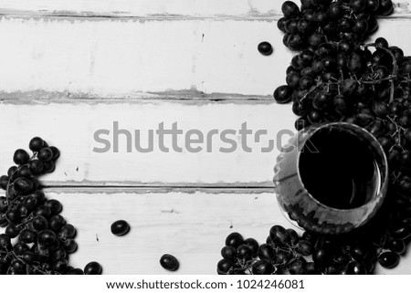 Grapes and wine on a wooden table black and white poster