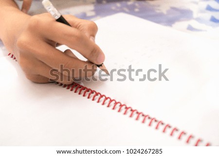 Woman hand writing on note book with copy space using as background business, education concept.