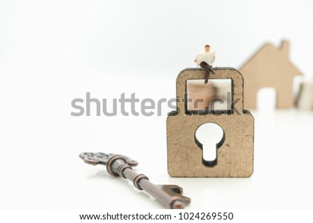 Miniature people: Business man reading book, news paper and key with copy space using as background business success, education concept.