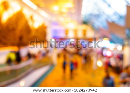 Abstract blur crowd people walking in trade fair expo in exhibition hall